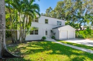 view of front of house with a front lawn and a garage