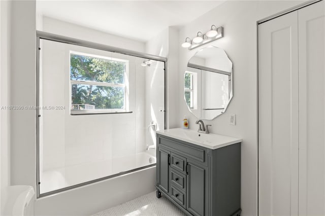 bathroom with shower / bath combination with glass door, tile patterned floors, and vanity