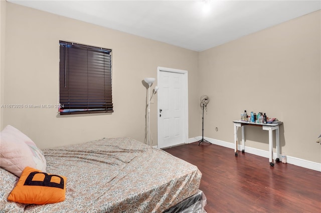 bedroom with dark hardwood / wood-style flooring