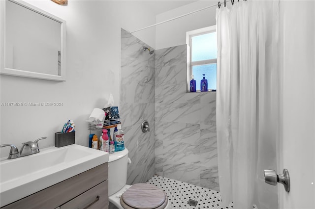 bathroom with toilet, vanity, and walk in shower