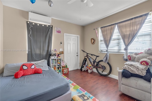 bedroom featuring ceiling fan, dark hardwood / wood-style floors, and an AC wall unit