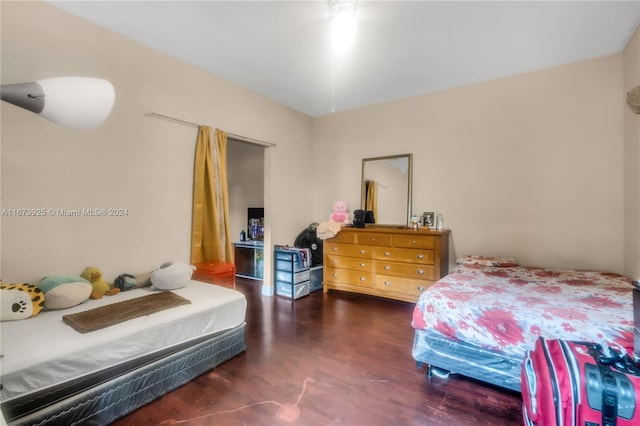 bedroom with dark hardwood / wood-style floors