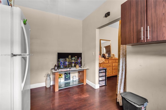 kitchen with white refrigerator and dark hardwood / wood-style flooring