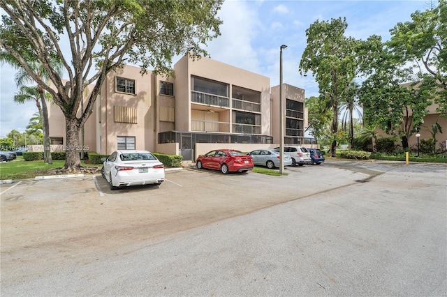 view of building exterior featuring uncovered parking