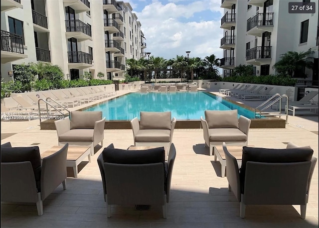 view of pool with a patio and an outdoor living space