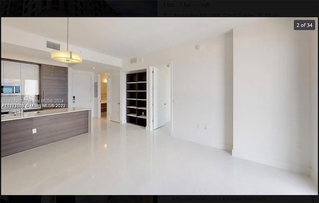 kitchen with hanging light fixtures and decorative backsplash