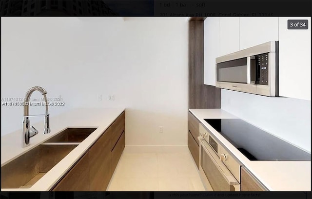 kitchen with appliances with stainless steel finishes and white cabinetry