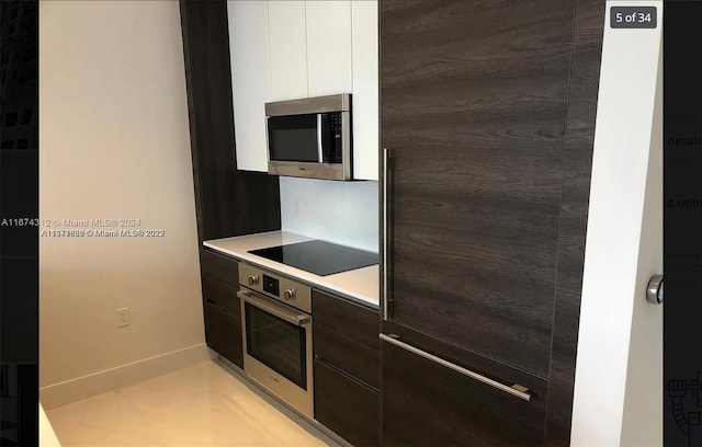 kitchen featuring dark brown cabinets, appliances with stainless steel finishes, and white cabinetry