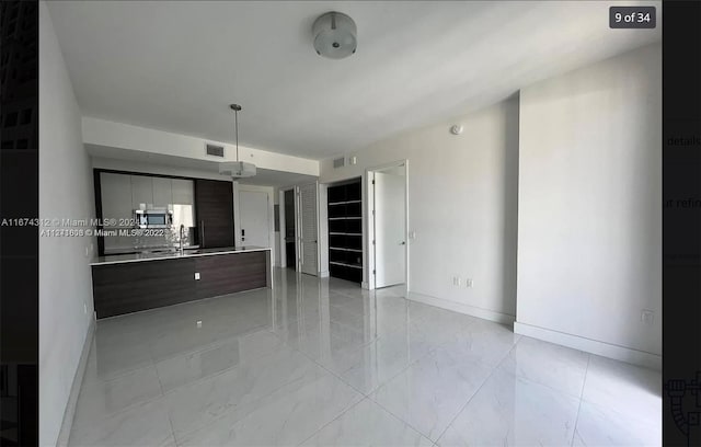 unfurnished living room with sink