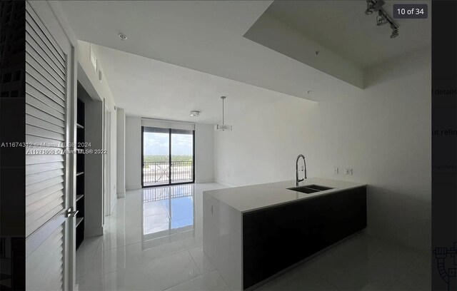 301 Altara Ave Unit Uph1008, Coral Gables, FL 33146 - kitchen featuring a sink, light tile patterned floors, hanging light fixtures, light countertops, and rail lighting