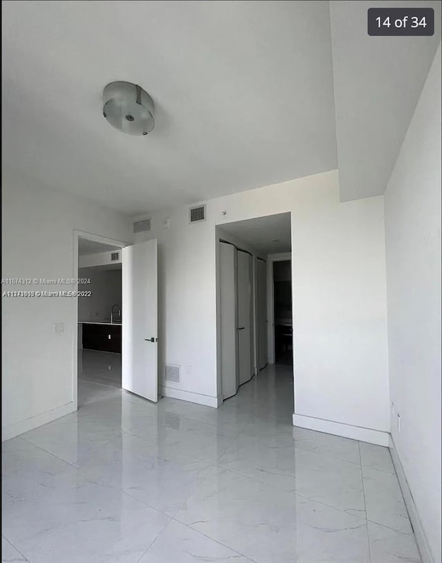 301 Altara Ave Unit Uph1008, Coral Gables, FL 33146 - unfurnished room featuring baseboards and light marble finish flooring