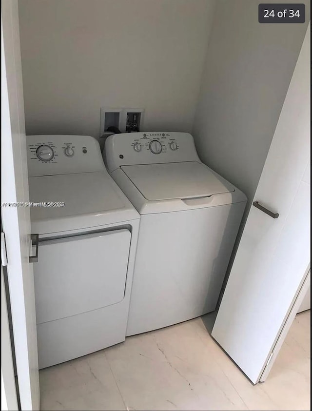 301 Altara Ave Unit Uph1008, Coral Gables, FL 33146 - laundry area featuring washer and clothes dryer and light marble finish floors