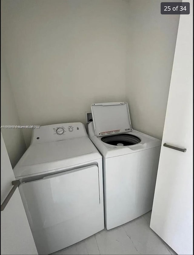 washroom with washing machine and clothes dryer