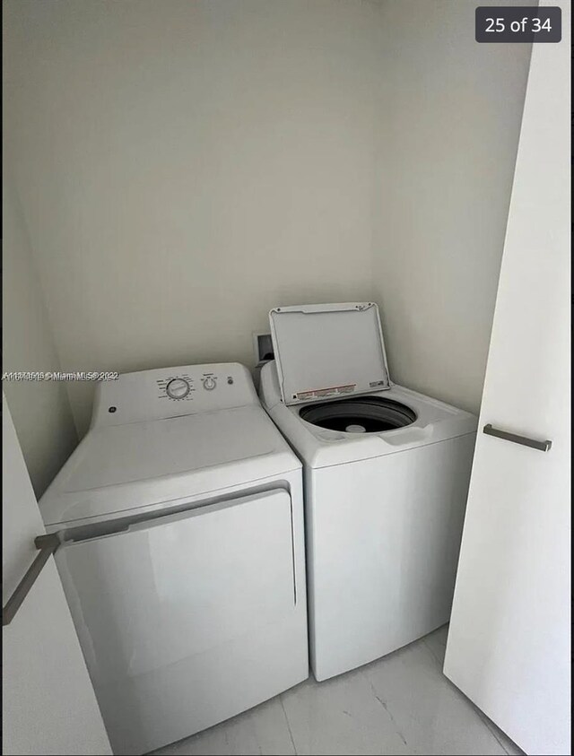 301 Altara Ave Unit Uph1008, Coral Gables, FL 33146 - laundry room featuring separate washer and dryer and light marble finish floors