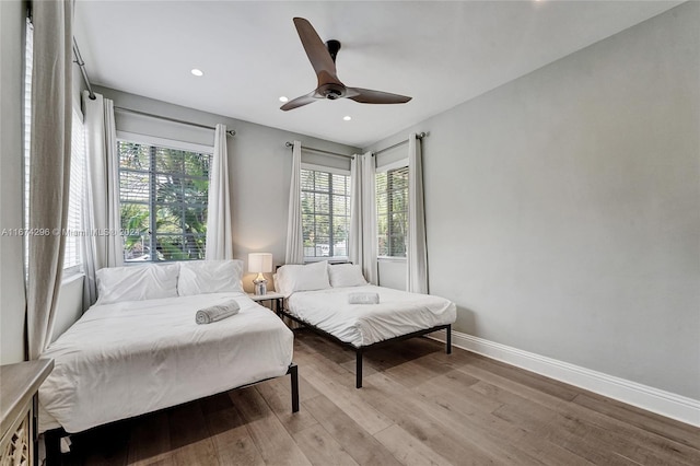 bedroom with ceiling fan and light hardwood / wood-style floors