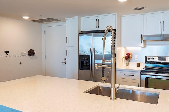 9066 SW 73rd Ct Unit 1205, Miami, FL 33156 - kitchen with stainless steel appliances, wall chimney exhaust hood, light stone countertops, a sink, and white cabinets