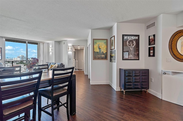 9066 SW 73rd Ct Unit 1205, Miami, FL 33156 - dining room featuring dark wood finished floors, a textured ceiling, and baseboards