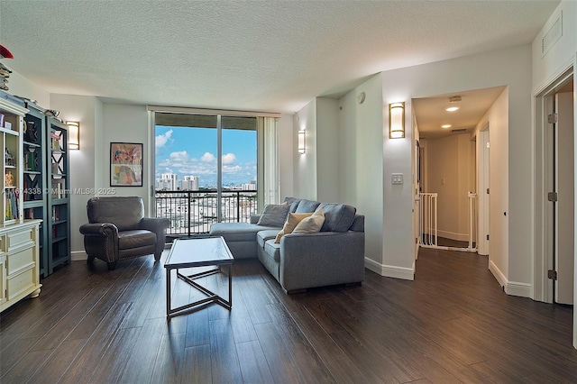 9066 SW 73rd Ct Unit 1205, Miami, FL 33156 - living room with dark wood-style floors, a wall of windows, a textured ceiling, and baseboards