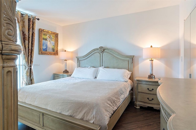 bedroom with dark wood-style flooring