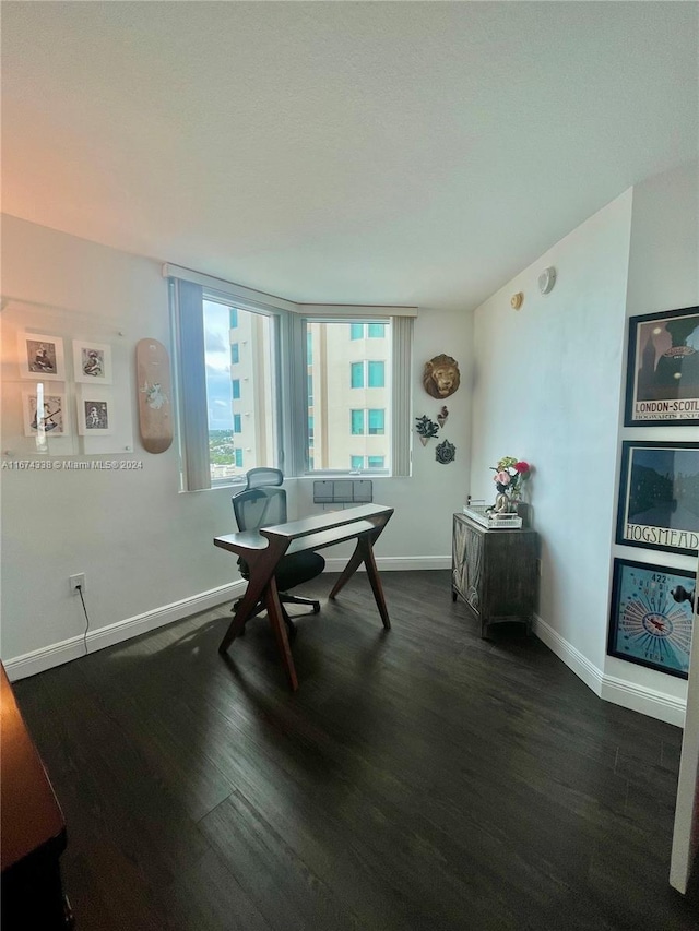 office space featuring baseboards and dark wood-type flooring