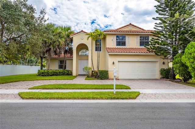 mediterranean / spanish-style home with a garage