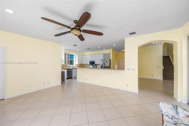 unfurnished living room with ceiling fan and light tile patterned floors