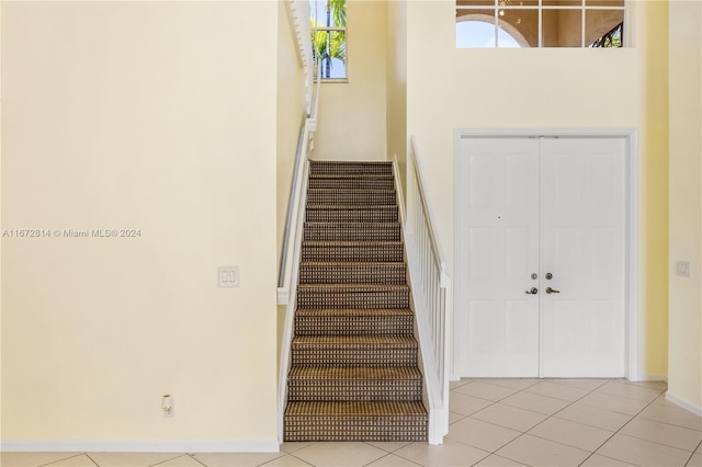 stairway featuring tile patterned flooring