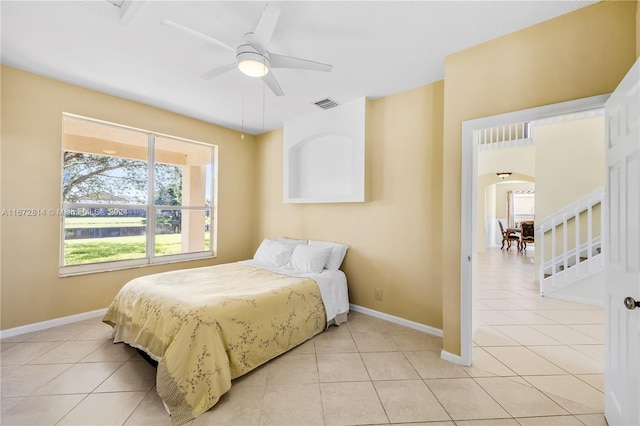 tiled bedroom with ceiling fan