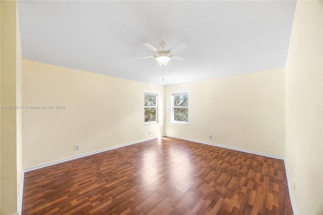 spare room featuring ceiling fan and dark hardwood / wood-style floors