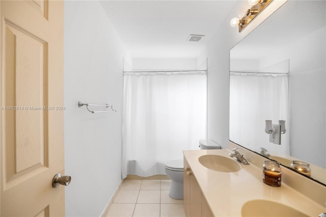 bathroom featuring vanity, tile patterned flooring, and toilet