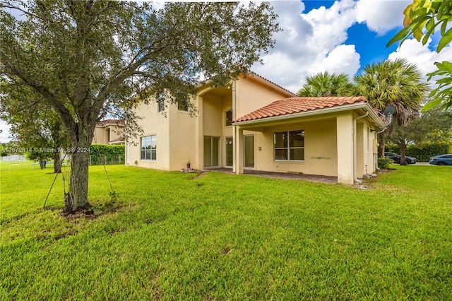 rear view of property with a lawn