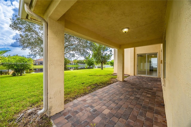 view of patio with a water view