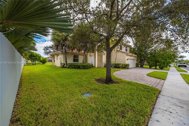 view of front of property with a garage and a front lawn