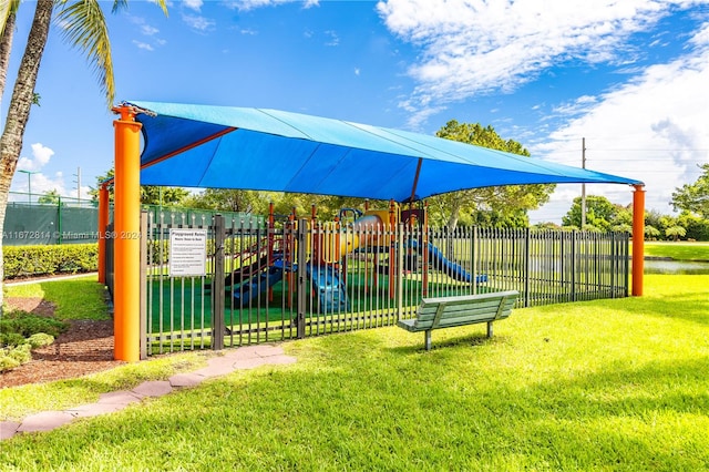 view of playground with a lawn