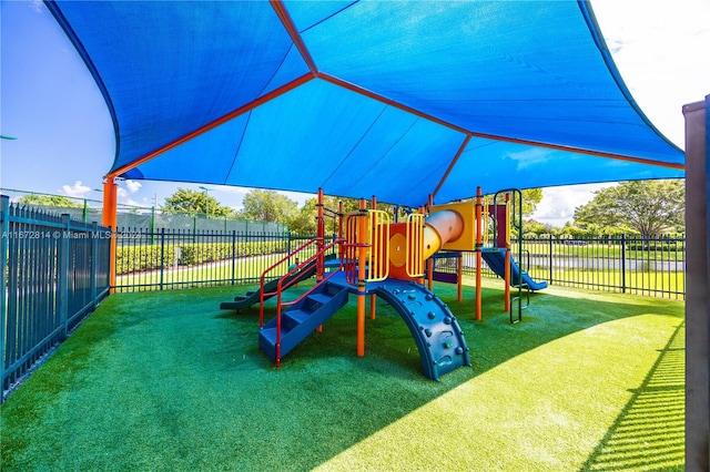 view of playground with a lawn