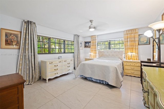 tiled bedroom featuring ceiling fan