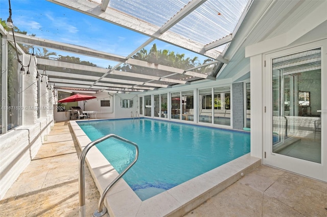 view of swimming pool with a patio area and glass enclosure