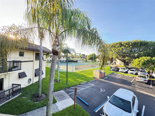 view of car parking featuring a lawn