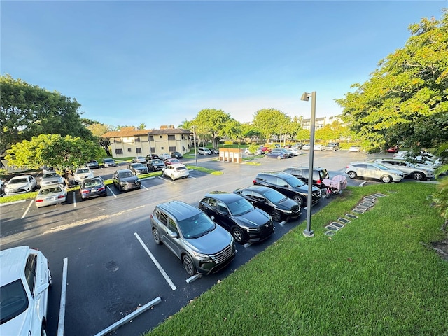 view of parking featuring a lawn