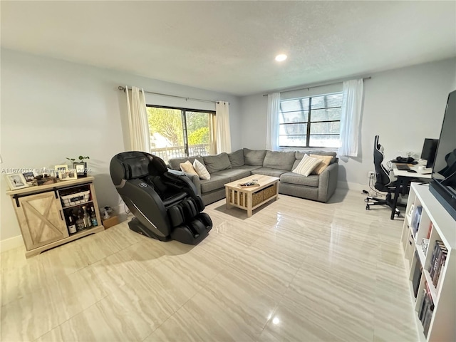 living room with light tile patterned floors and a wealth of natural light