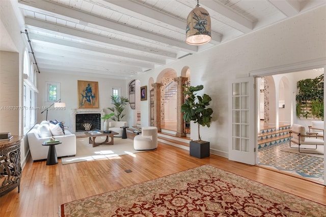 living room featuring beam ceiling and hardwood / wood-style flooring