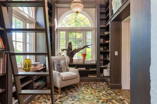 sitting room featuring plenty of natural light and an inviting chandelier