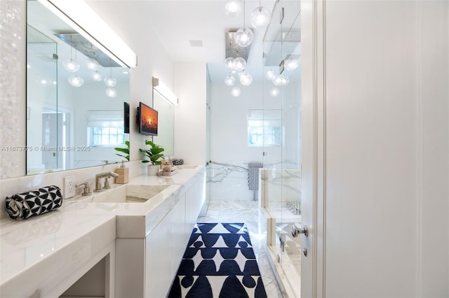 bathroom with vanity and a shower with shower door