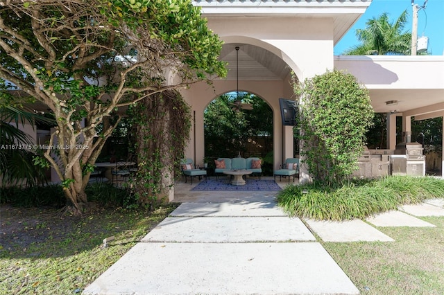 view of home's community featuring a patio, an outdoor hangout area, and exterior kitchen