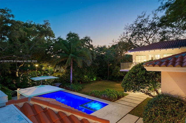 pool at dusk with a yard