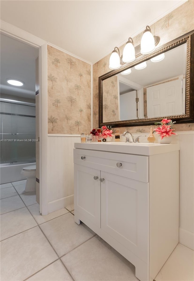 18071 Biscayne Blvd Unit 303, Aventura, FL 33160 - bathroom featuring vanity, toilet, enclosed tub / shower combo, a wainscoted wall, and wallpapered walls