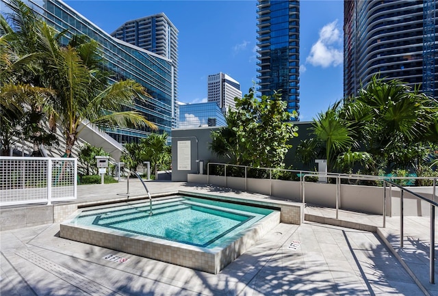 view of pool with a hot tub