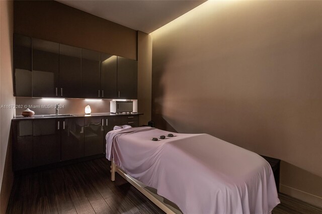 bedroom featuring sink and dark hardwood / wood-style floors