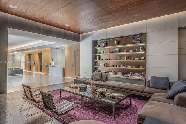 living room featuring built in shelves, wooden ceiling, and light hardwood / wood-style floors