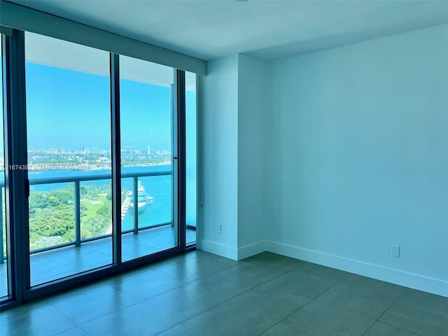 888 Biscayne Blvd Unit 1811, Miami, FL 33132 - tiled empty room featuring baseboards and a view of city